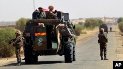 French Troops dismount to secure a demining team clearing the road near Hambori, northern Mali, on the road to Gao, February 4, 2013. 