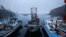 FILE - A fisherman sits on his boat in a small port on the island of Baengnyeong, which lies on the South Korean side of the Northern Limit Line, in the Yellow Sea, April 11, 2014.