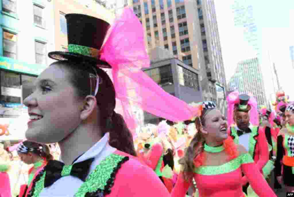 Costumed members of the Spirit of American Dance group take part in the 85th Annual Macy's Thanksgiving Day Parade Thursday Nov. 24, 2011 in New York. A jetpack-wearing monkey and a freakish creation from filmmaker Tim Burton are two of the big new balloo