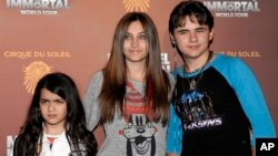 FILE - This Jan. 27, 2012 file photo shows, from left, Blanket Jackson, Paris Jackson, and Prince Michael Jackson at the opening night of the Michael Jackson The Immortal World Tour in Los Angeles.