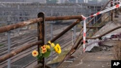 Plastic flowers were left at the scene of a bus accident in Mestre, near the city of Venice, Italy, on Oct. 4, 2023. The bus fell from an elevated road late Tuesday, killing 21 people.