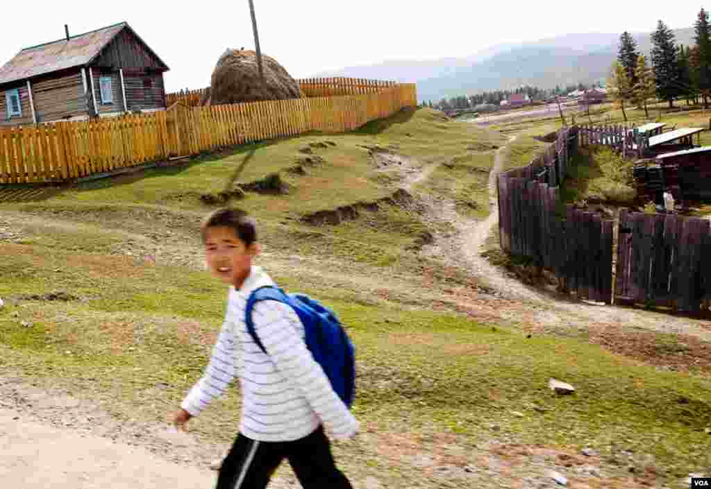 A young Altai boy walks to school, where he will study in Russian and Altai, the region’s Turkic language. An Altai population boom means that within a generation, Altai people will probably displace Russians as the ethnic majority.