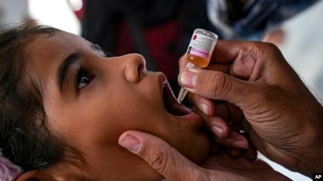 A health worker administers a polio vaccine to a child at a hospital in Deir al-Balah, central Gaza Strip, Sept. 1, 2024.