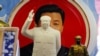 Sculptures of the late Chinese Chairman Mao Zedong are placed in front of a souvenir plate featuring a portrait of Chinese President Xi Jinping at a shop next to Tiananmen Square in Beijing, China, March 1, 2018. 