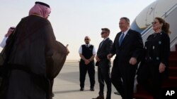 US Secretary of State Mike Pompeo, second right, and his wife Susan are met by a member of Saudi protocol as they arrive at the King Khalid International Airport in the Saudi capital Riyadh, Feb. 19, 2020.
