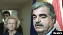 FILE - Lebanese Prime Minister Rafiq Hariri (R) answers reporters' questions during a joint press conference with European Parliament President Nicole Fontaine after their meeting in Brussels, Jan. 10, 2002. 