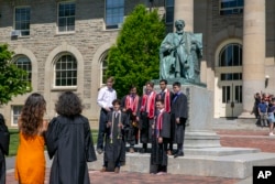 FILE - Students celebrate graduating from Cornell University in Ithaca, New York, on Friday, May 26, 2023. (AP Photo/Ted Shaffrey)