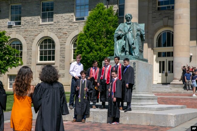 FILE - Students celebrate graduating from Cornell University in Ithaca, New York, on Friday, May 26, 2023. (AP Photo/Ted Shaffrey)