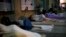 Homeless people sleep outside the public defenders office in Rio de Janeiro, Brazil, Dec. 6, 2017.