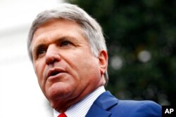 FILE - Rep. Mike McCaul, R-Texas, speaks with members of the media outside of the White House, Oct. 16, 2019.