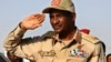 (FILE) In this June 15, 2019 file photo, Gen. Mohammed Hamdan Dagalo salutes during a rally, in Galawee, northern Sudan.