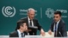 Mukhtar Babayev, COP29 President, center, arrives to a news conference next to Yalchin Rafiyev, left, Azerbaijan's COP29 lead negotiator, during the COP29 U.N. Climate Summit, Nov. 18, 2024, in Baku, Azerbaijan.