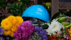 A Habitat for Humanity hard hat is among the items left in tribute to former President Jimmy Carter at the entrance to the Jimmy Carter Presidential Center, Dec. 31, 2024, in Atlanta, Georgia.
