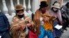 Women knit while waiting for the AstraZeneca vaccine for COVID-19 at a government-run social security clinic during vaccinations for people over age 80 in La Paz, Bolivia.