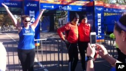 Dressed to run, people pose for photos at the finish line for the 2012 New York Marathon, Saturday, Nov. 3, 2012 in New York’s Central Park.