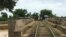 A bamboo train railroad over a bridge passing a pond, in Battambang, on July 21, 2017. The railroad will be repaired in the upcoming months. (Sun Narin/VOA Khmer)
