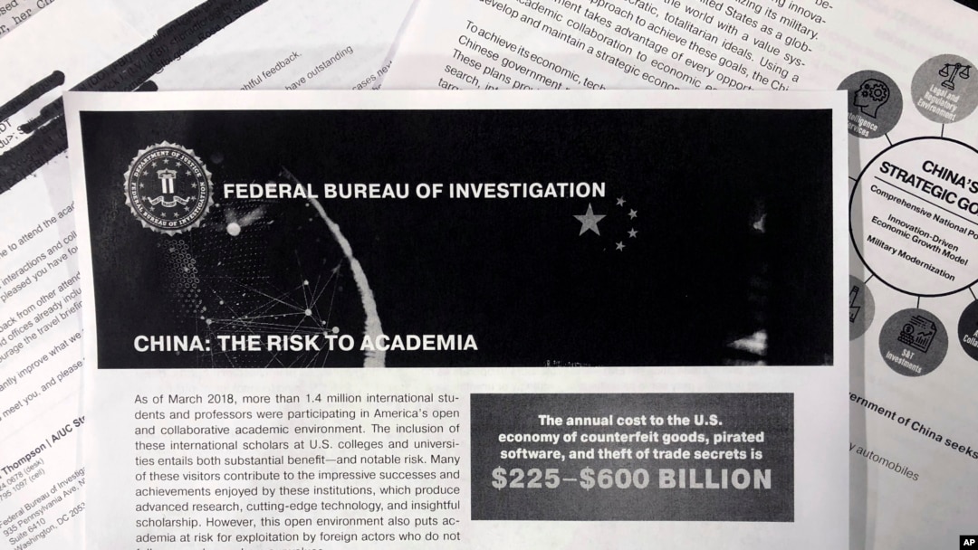 A photo shows a copy of an FBI pamphlet and related emails, Oct. 4, 2019. The FBI’s outreach to American colleges about the threat of economic espionage includes this pamphlet that warns specifically about efforts by China to steal academic research.
