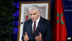 Israeli Foreign Minister Yair Lapid gestures as he speaks to media during a press conference in Casablanca, Morocco, Aug. 12, 2021. 