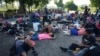 FILE - Migrants who are part of a caravan heading toward Mexico's northern border and ultimately the U.S., rest in southern Mexico, Nov. 7, 2024. Mexican immigration authorities have broken up two small migrant caravans headed to the U.S. border, activists said on Saturday. 