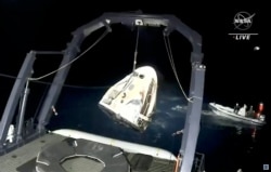 In this image made from NASA TV video, the SpaceX Dragon capsule is retrieved from the Gulf of Mexico near the Florida Panhandle early May 2, 2021.
