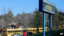 A woman walks onto the campus of the Franklin Regional School District where several people were stabbed at Franklin Regional High School, Murrysville, Pennsylvania, April 9, 2014. 