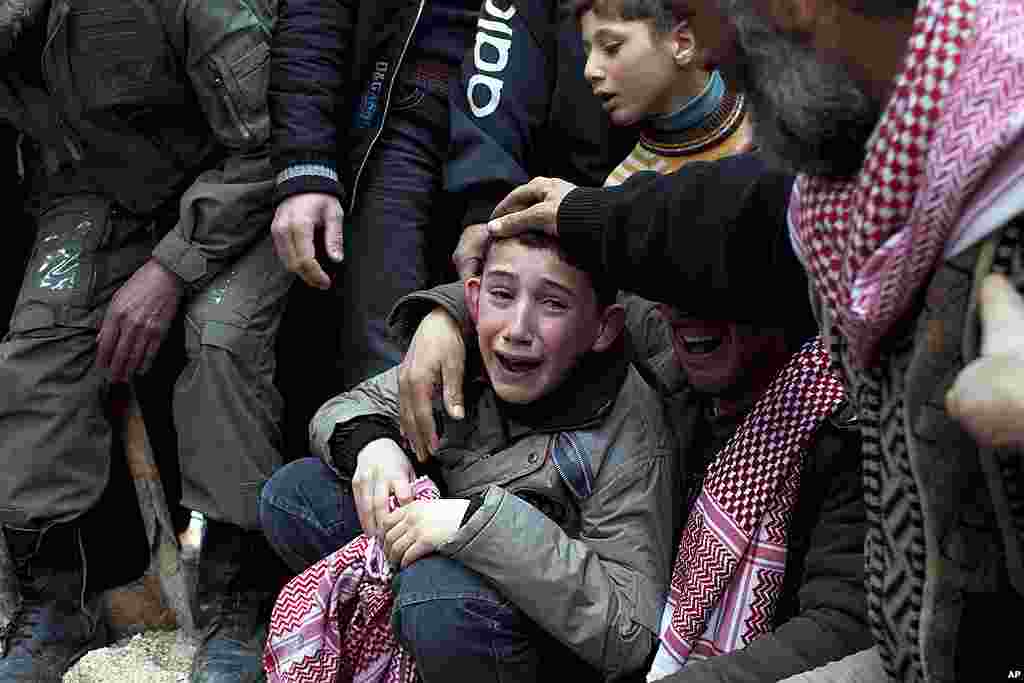 Ahmed, center, mourns his father Abdulaziz Abu Ahmed Khrer, who was killed by a Syrian Army sniper, during his funeral in Idlib, March 8, 2012. (AP)