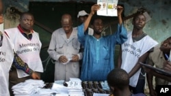 Guinean election officials count votes after the closing of the polls at an outdoor polling station in Conakry, Guinea. (file)