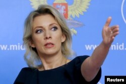 FILE - Russian Foreign Ministry spokesperson Maria Zakharova gestures during a news briefing in Moscow, Russia, Oct. 6, 2015. Zakharova has called the planned search a "direct threat to the security of Russian citizens."