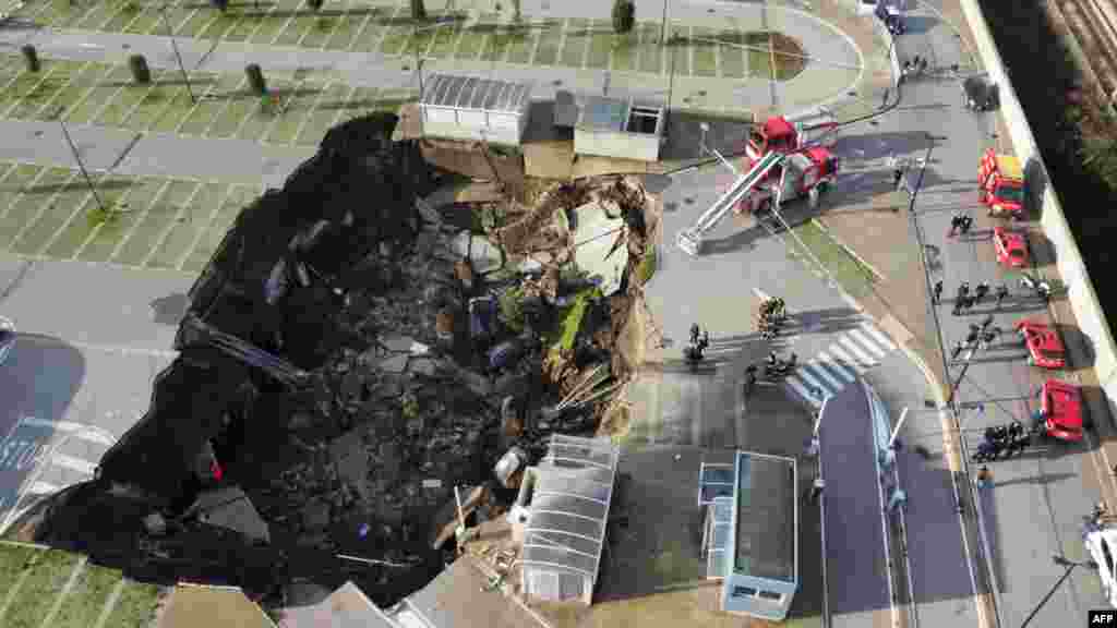 A aerial view shows a sinkhole in the Ospedale del Mare hospital car park, where people go for COVID-19 testing, on the outskirts of the city of Naples, after the ground collapsed, destroying some vehicles.
