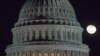 FILE - The moon rises behind the U.S. Capitol Dome in Washington, Dec. 30, 2012.