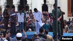An Indonesian man charged with having gay sex is publicly caned outside a mosque in Banda Aceh, Aceh province, Indonesia, July 13, 2018.