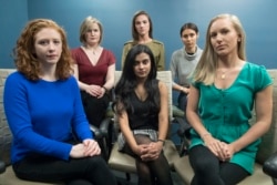 In this Wednesday, Nov. 14, 2018 photo from left back row, Annemarie Brown, Andrea Courtney, and Marissa Evans, and from left front row, Sasha Brietzke, Vassiki Chauhan, Kristina Rapuano, pose in New York. They filed a lawsuit against Dartmouth College.
