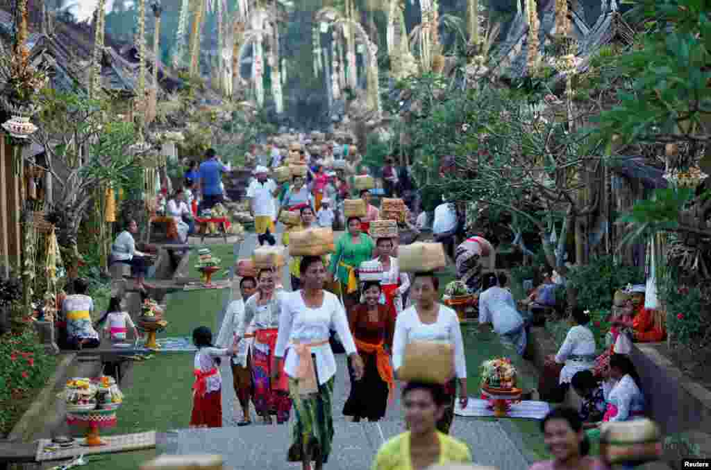 Balinese Hindus carry offerings while celebrating the Galungan religious holiday at Penglipuran village in Bangli Regency, on the resort island of Bali, Indonesia.