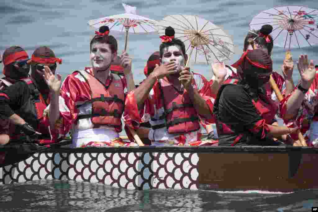 Teams gesture towards spectators ahead of the race at the Hong Kong Dragon Boat Carnival.