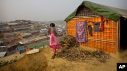 A Rohingya Muslim girl wears a sweater standing outside her tent at Balukhali refugee camp 50 kilometres (32 miles) from Cox's Bazar, Bangladesh, Jan. 14, 2018. 