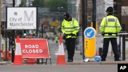 Police officers stand guard close to Victoria Railway Station in Manchester, Britain, May 24, 2017.