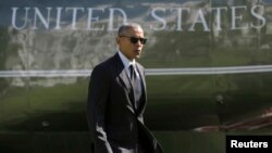 FILE - U.S. President Barack Obama walks near his Marine One helicopter by the White House in Washington, Oct. 14, 2016. 