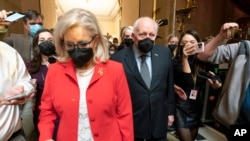 Former Vice President Dick Cheney walks with his daughter Rep. Liz Cheney, R-Wyo., vice chair of the House panel investigating the Jan. 6 U.S. Capitol insurrection, in the Capitol Rotunda at the Capitol in Washington, Jan. 6, 2022.