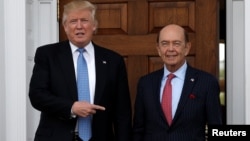 FILE - U.S. President-elect Donald Trump stands with Wilbur Ross after their meeting at Trump National Golf Club in Bedminster, New Jersey, Nov. 20, 2016.