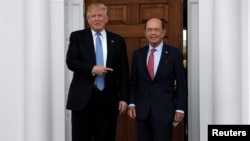 U.S. President-elect Donald Trump stands with Wilbur Ross after their meeting at Trump National Golf Club in Bedminster, New Jersey, U.S., Nov. 20, 2016. 