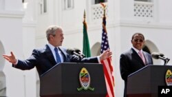  FILE – President George W. Bush speaks at a news conference with then-Tanzanian President Jakaya Mrisho Kikwete in Dar es Salaam, while on a five-nation visit to Africa, Feb. 17, 2008. The law that transformed the battle against HIV/AIDS in developing countri