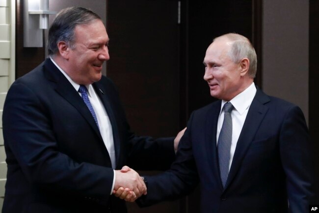 Russian President Vladimir Putin, right, and U.S. Secretary of State Mike Pompeo, shake hands prior to their talks in the Black Sea resort city of Sochi, southern Russia, May 14, 2019.
