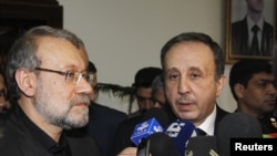 Syrian Parliament speaker Mohammed Jihad al-Laham (R) and his Iranian counterpart Ali Larijani speak to the media in Damascus, Syria, November 23, 2012.