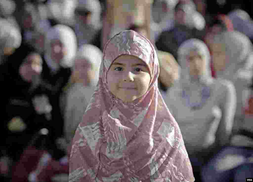Miri, a 6 year old Muslim girl, poses for a picture after Eid al-Fitr prayers in Bucharest, Romania, Aug. 30, 2011. AP