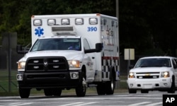 An ambulance transporting an American infected with the deadly Ebola virus from West Africa, leaves Dobbins Air Reserve Base in Marietta, Ga., headed for Emory University Hospital in Atlanta, Sept. 9, 2014.