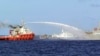 In this photo released by Vietnam Coast Guard, a Chinese ship (L) shoots a water cannon at a Vietnamese vessel (R) while a Chinese Coast Guard ship (C) sails alongside in the South China Sea, off Vietnam's coast, May 7, 2014. 