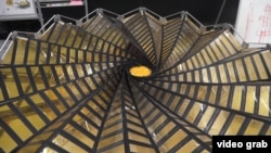 This image taken from video shows the center of the NASA project Starshade, which can unfurl and fold back up. (E. Lee/VOA)