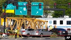 Emergency crews work at the scene of a construction crane collapse where several people were killed and others injured, April 27, 2019, in the South Lake Union neighborhood of Seattle. 