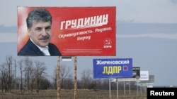 Billboards, which advertise the campaign of candidates in the upcoming presidential election for Pavel Grudinin, left, and Vladimir Zhirinovsky, second left, are on display near a road outside Stavropol, Russia, March 4, 2018.