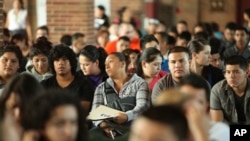 Undocumented people wait to fill out application forms for the Deferred Action for Childhood Arrivals program on August 15, 2012 at Navy Pier in Chicago, Illinois.